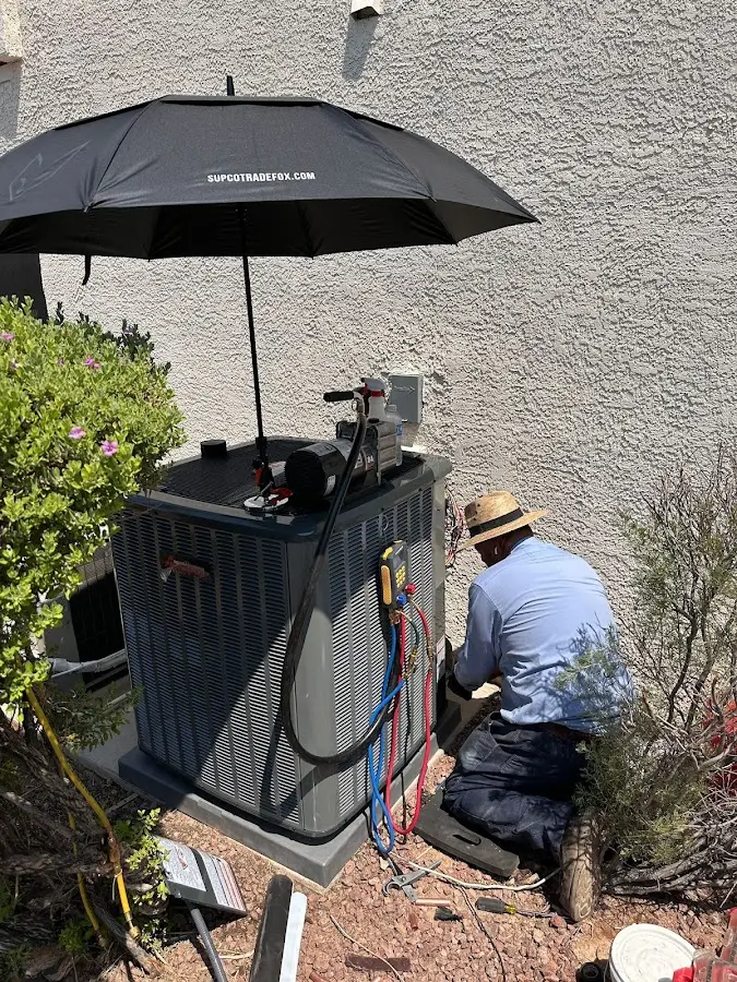 HVAC technician performing outdoor AC maintenance in Denville
